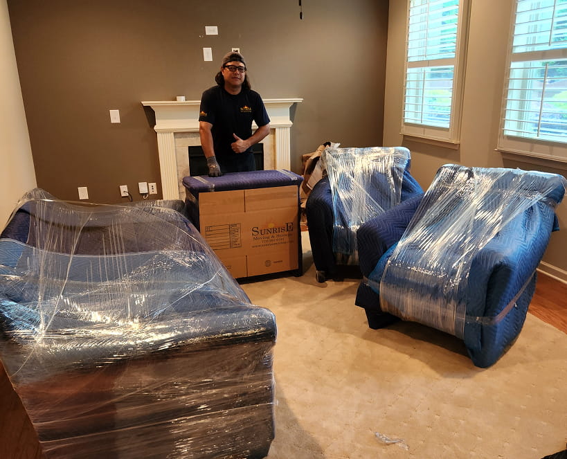 a sunrise moving & storage crew member wraps furniture as part of a residential move